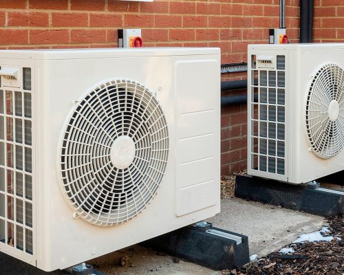 pair of heat pump repairs outside 1