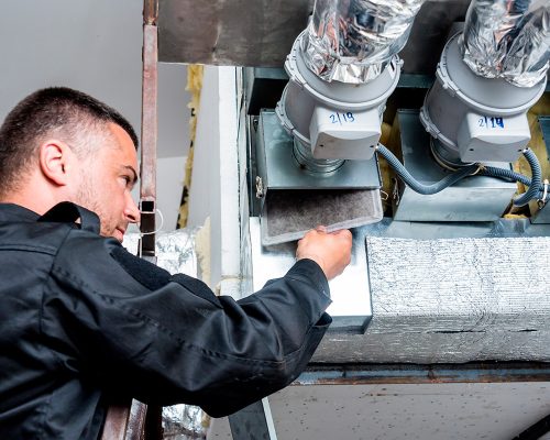 worker fixing installation the duct for hvac