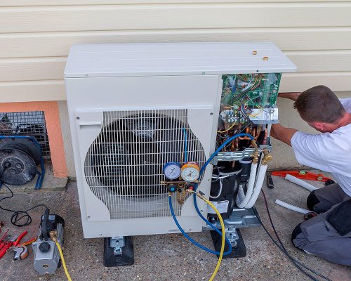 worker fixing the heat pump repair in the hvac 1