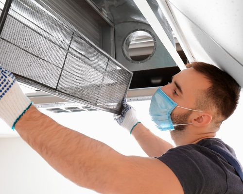 young repairing the air duct